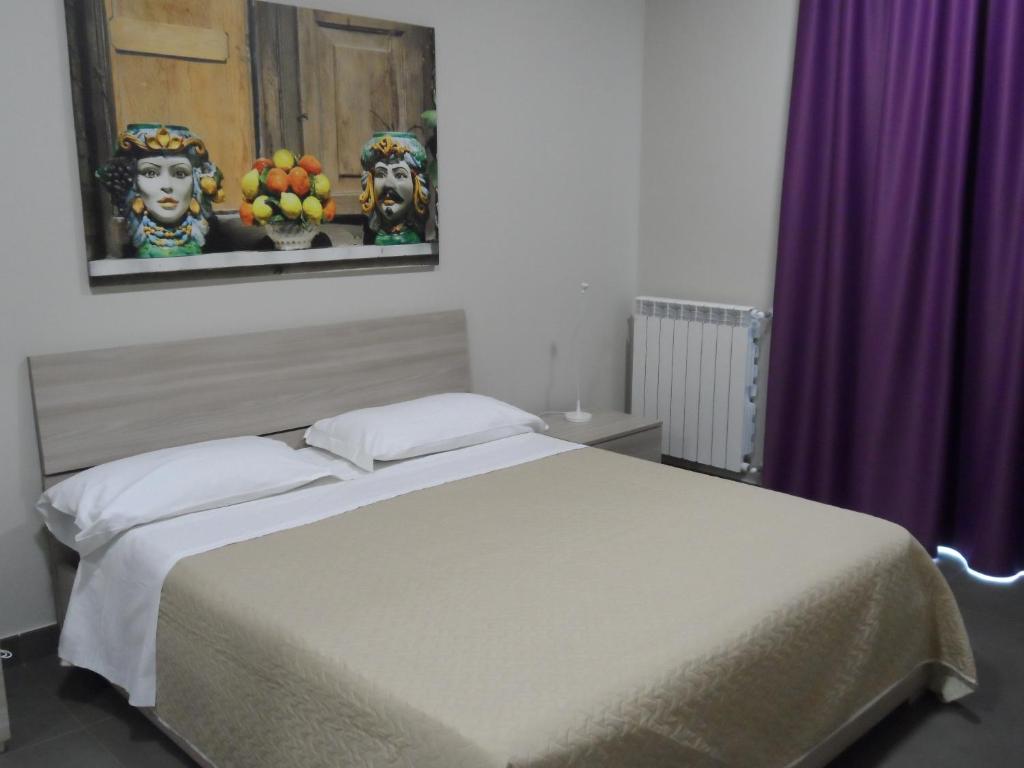 sypialnia z łóżkiem i fioletową zasłoną w obiekcie Residence I Dioscuri by RECEPTIO w Katanii