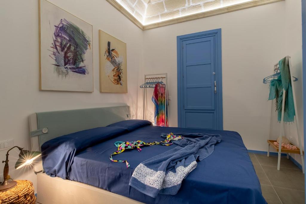una camera con un letto e una coperta blu di Suite&Maré a Favignana