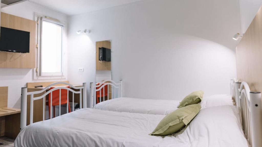 Postel nebo postele na pokoji v ubytování Welcomotel Limoges