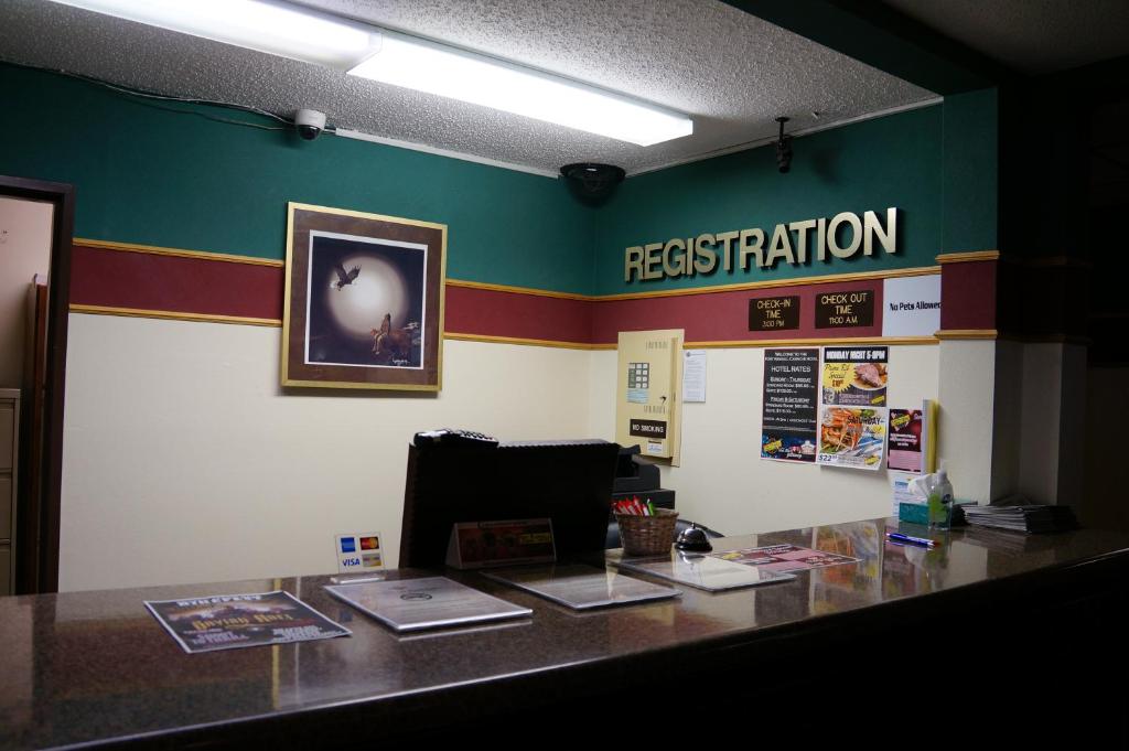 an office with a desk with a registration sign on the wall at Fort Randall Casino & Hotel in Pickstown