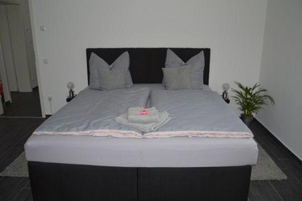 ein großes Bett mit einem schwarzen und weißen Bettrahmen in der Unterkunft Home Nr.5 in Roßwein