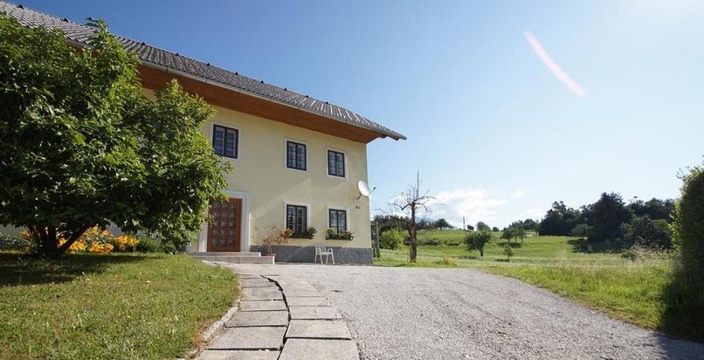 a large white house with a gravel road at Marta's House in Bled