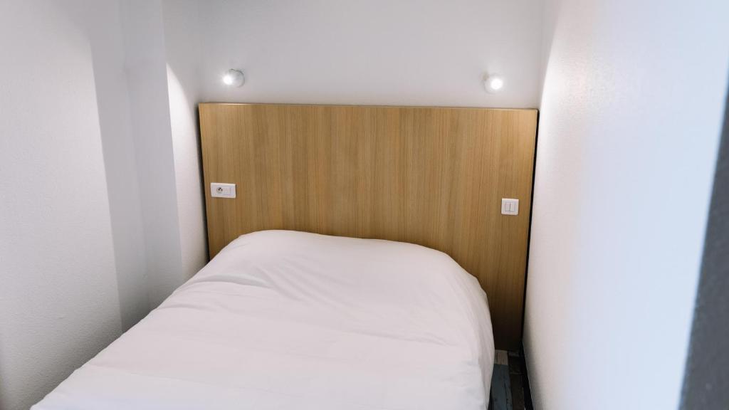 Postel nebo postele na pokoji v ubytování Welcomotel Limoges