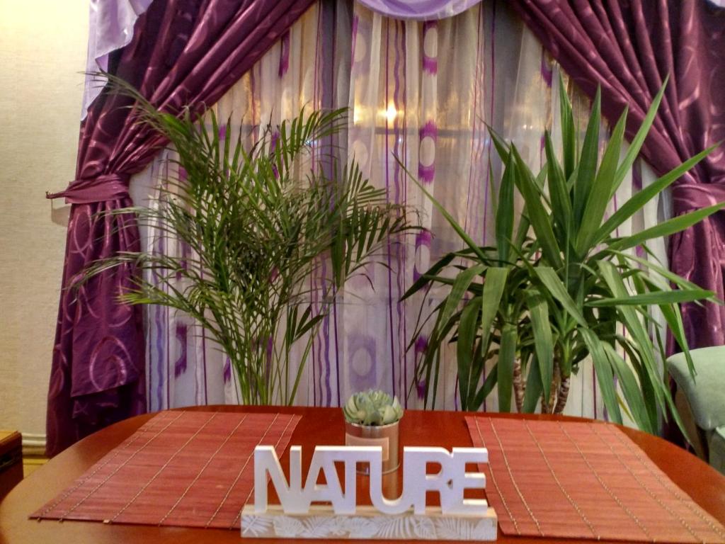 a table with a nine sign on it in front of plants at MAXX Lake Apart in Bacău