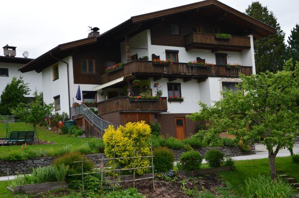 una casa con balcones y un jardín frente a ella en Ferienwohnung Garber, en Uderns