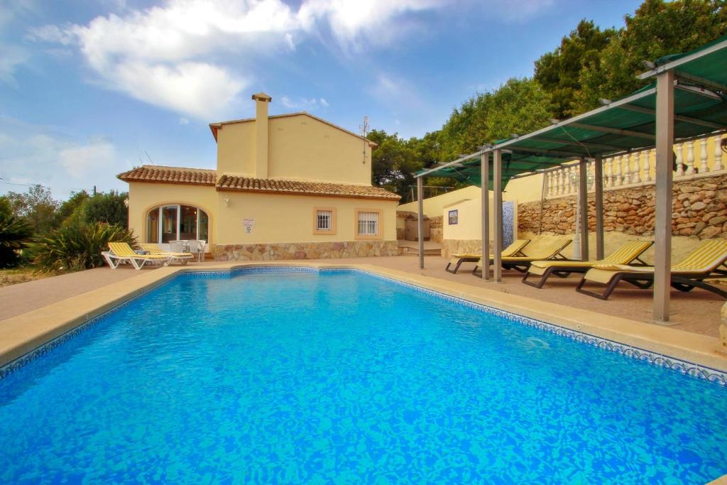 a villa with a swimming pool and a house at Estrelizia - pretty holiday property with garden and private pool in Calpe in Calpe