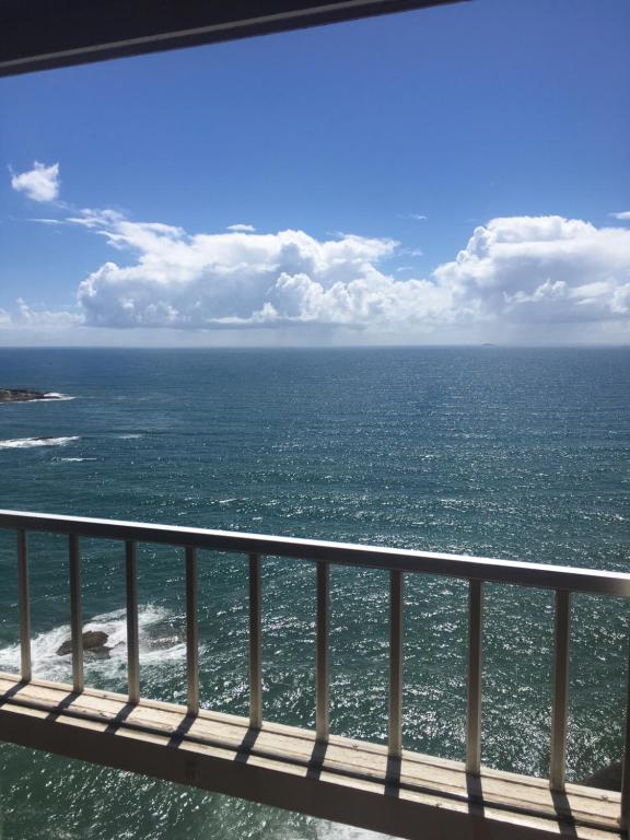 a view of the ocean from a pier at Guarapari ES apartamento frente para o mar in Guarapari