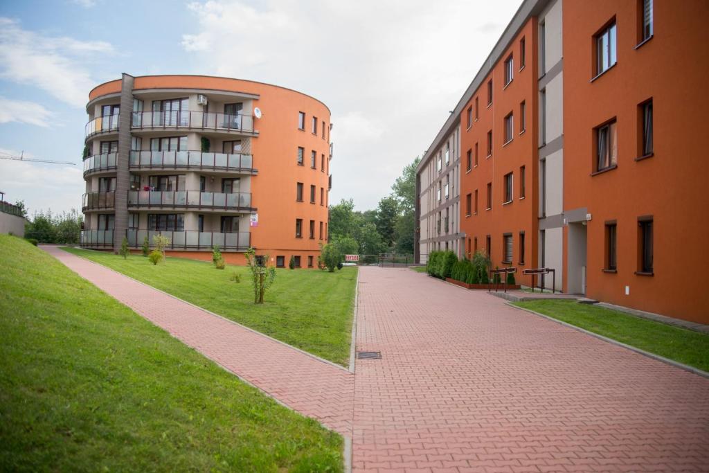 an empty street in front of two buildings at Apartament in Krakow