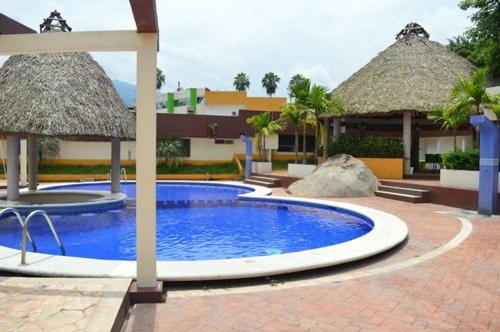 a large swimming pool in front of a resort at Hotel Jardin Real in Huixtla