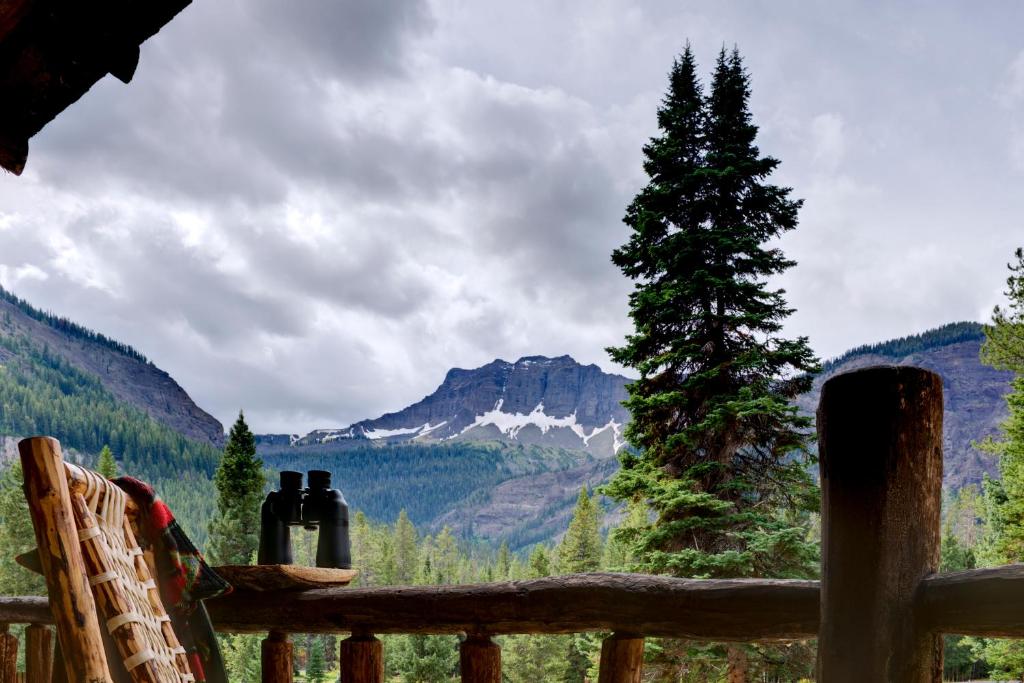 a porch with bottles of wine and a tree at Silver Gate Lodging in Cooke City