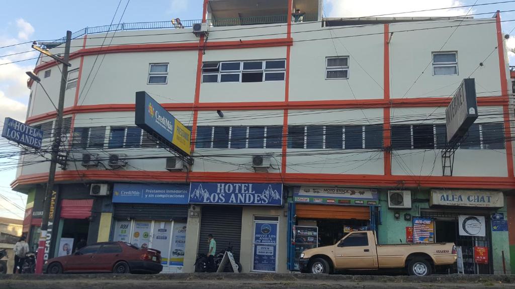 a building with a truck parked in front of it at Hotel Los Andes Tegucigalpa in Tegucigalpa