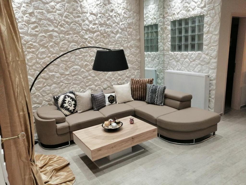 a living room with a couch and a coffee table at Olive Grove Deluxe apartment in Agnítsini