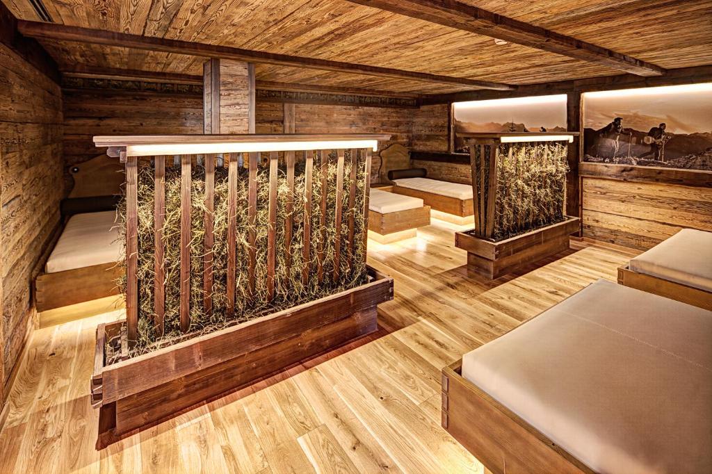 a room with three beds in a cabin at Sporthotel Silvretta Montafon in Gaschurn