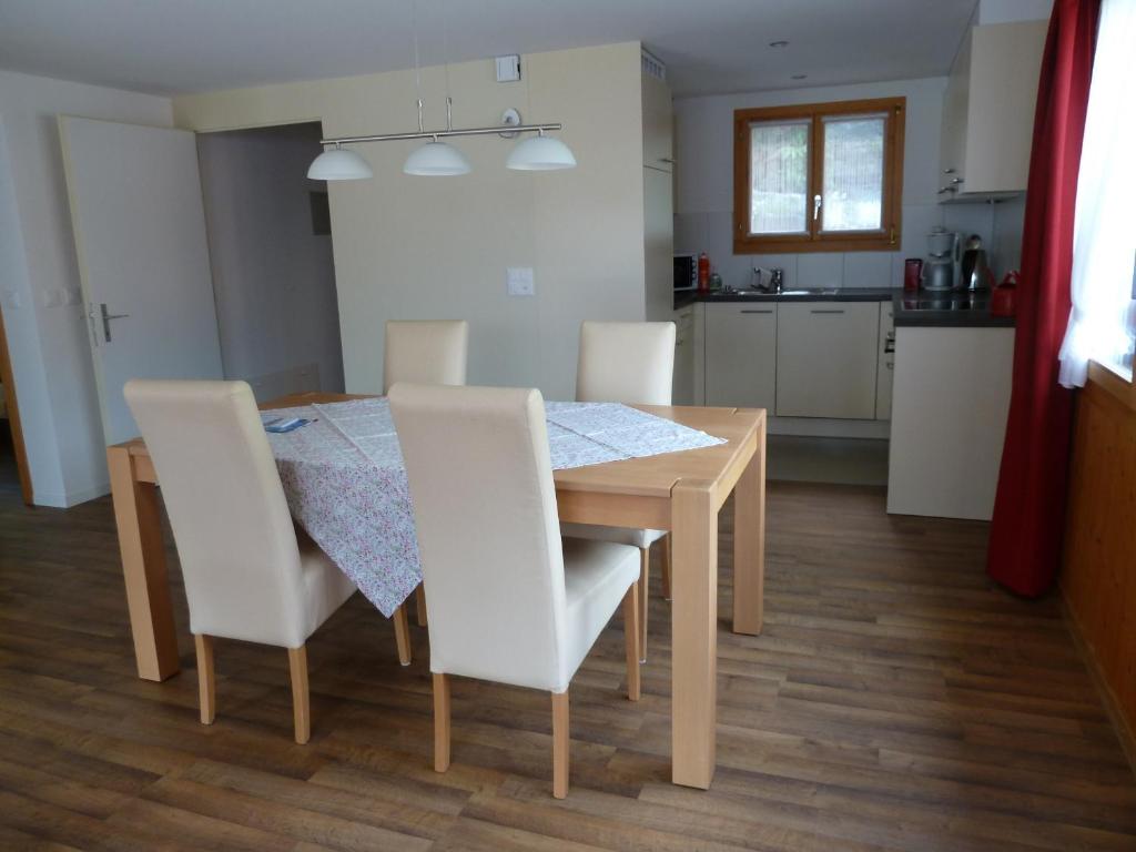 a kitchen and dining room with a table and chairs at Chalet Gerbera in Wengen
