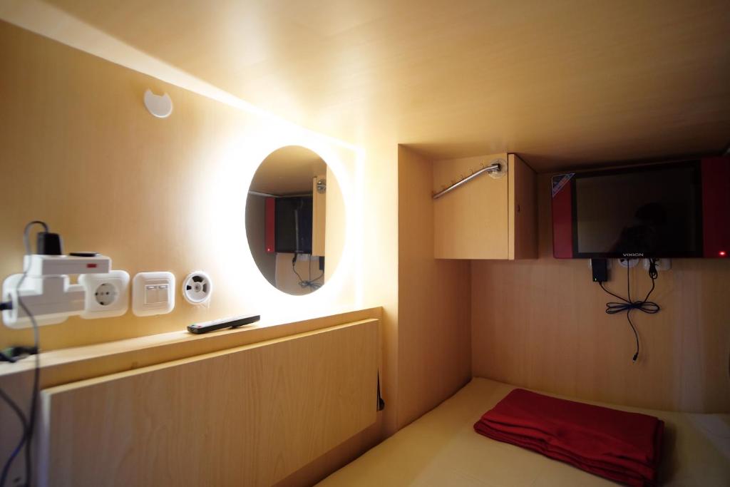 A television and/or entertainment centre at INAP at Capsule Hostel