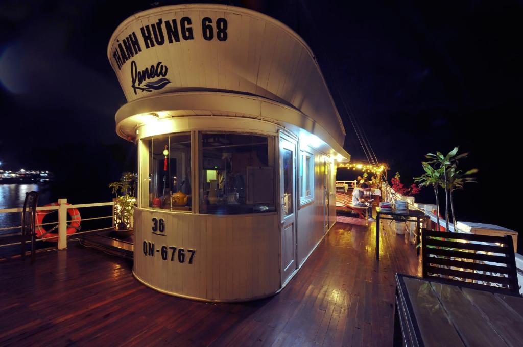 a boat sitting on top of a deck at night at Renea Cruises Halong in Ha Long