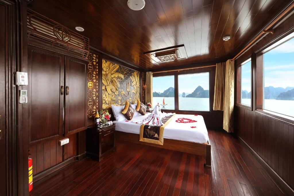 a bedroom with a bed in a boat at Renea Cruises Halong in Ha Long