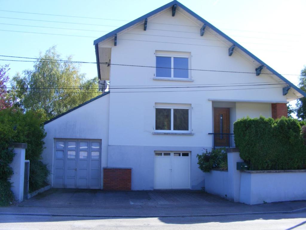 a white house with a garage at au sapin des vosges in Saint-Étienne-lès-Remiremont