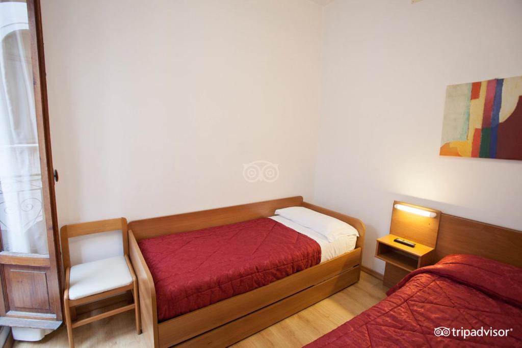 Postel nebo postele na pokoji v ubytování Hotel Caprera
