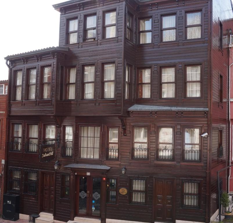 an old wooden building on the corner of a street at Hotel SultanHill in Istanbul