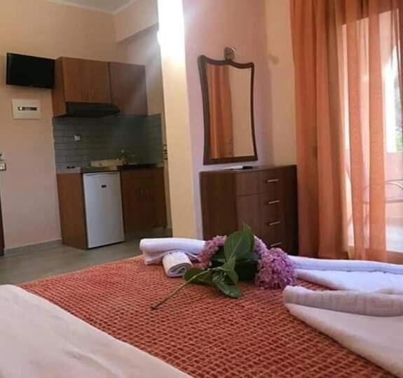 a bedroom with a bed with towels and flowers on it at Studios Anna Paradise in Skala Potamias