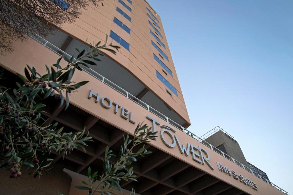 a hotel sign on the side of a building at Hotel Tower Inn & Suites in San Rafael