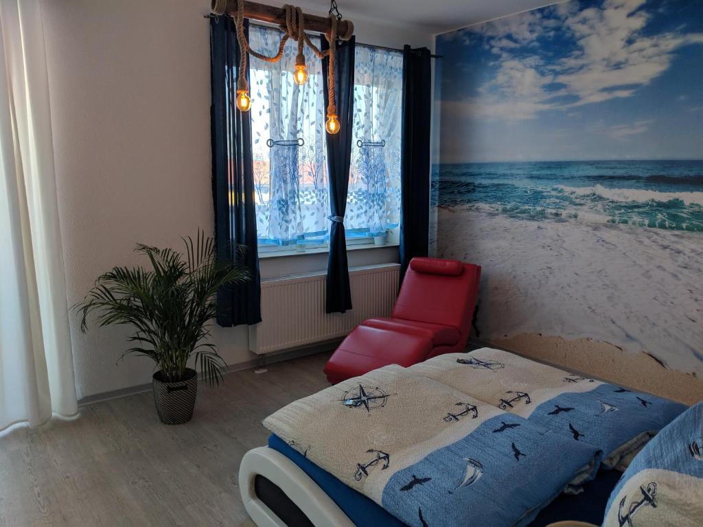 a bedroom with a bed and a painting of the ocean at Café & mehr in Halle an der Saale