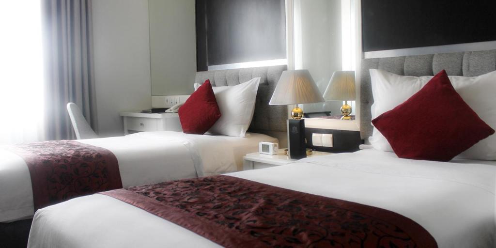 Postel nebo postele na pokoji v ubytování Gino Feruci Braga by KAGUM Hotels