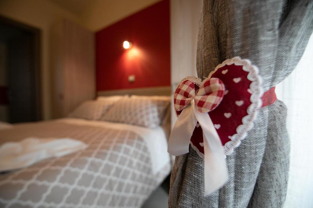 a valentines heart hanging from a curtain in a bedroom at La Madonnina in Nicosia