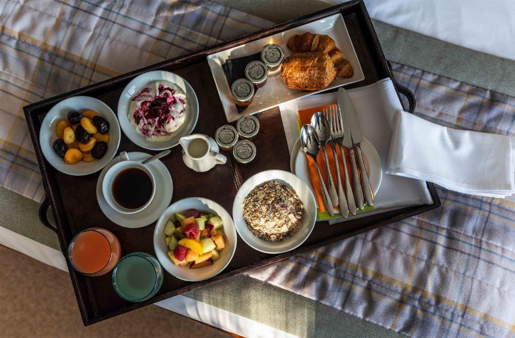 a tray of breakfast food on a bed at The White Lion Hotel in Aldeburgh