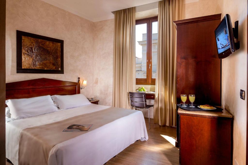 a hotel room with a bed and a television at Hotel San Francesco in Rome