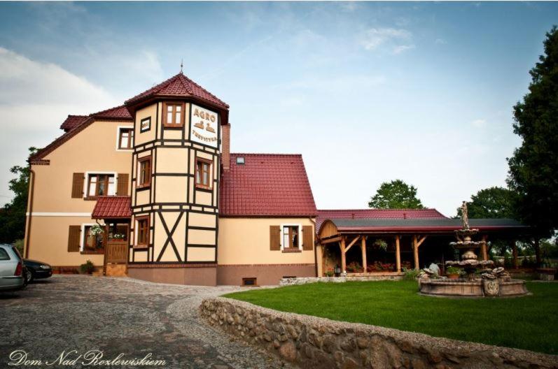 a large building with a clock on the side of it at Dom Nad Rozlewiskiem in Połczyn-Zdrój