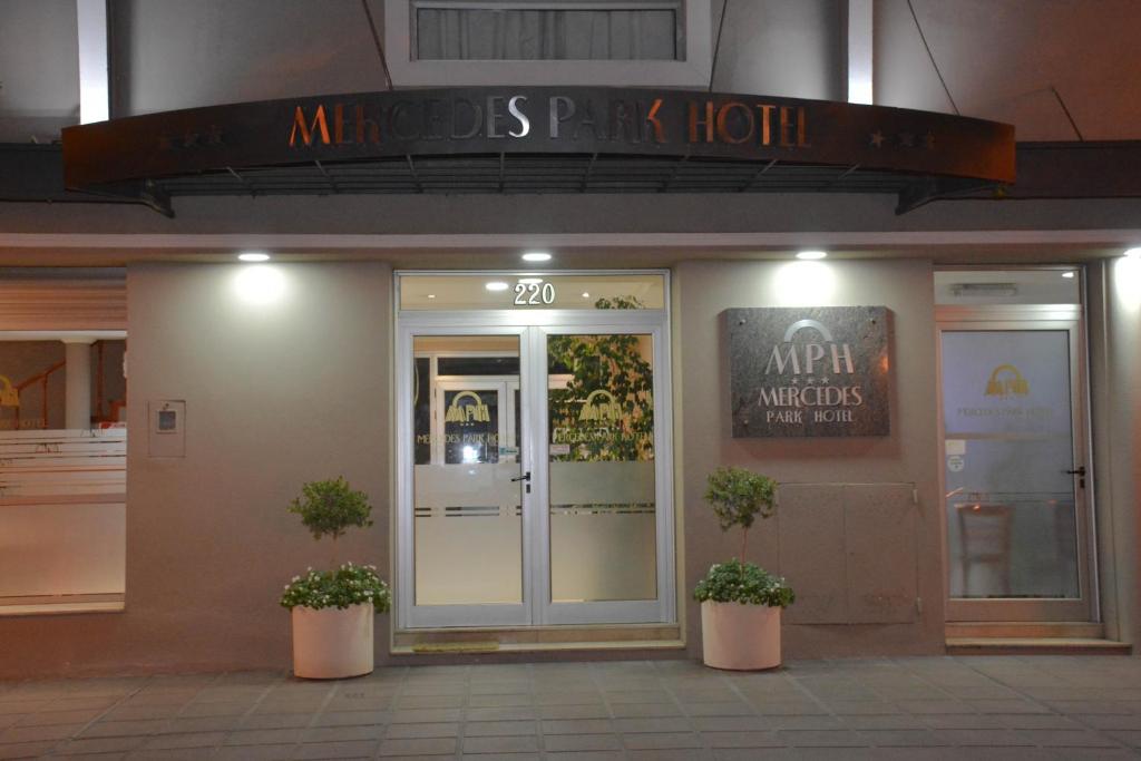 an entrance to an entrance to an office with two potted plants at Mercedes Park Hotel in Villa Mercedes