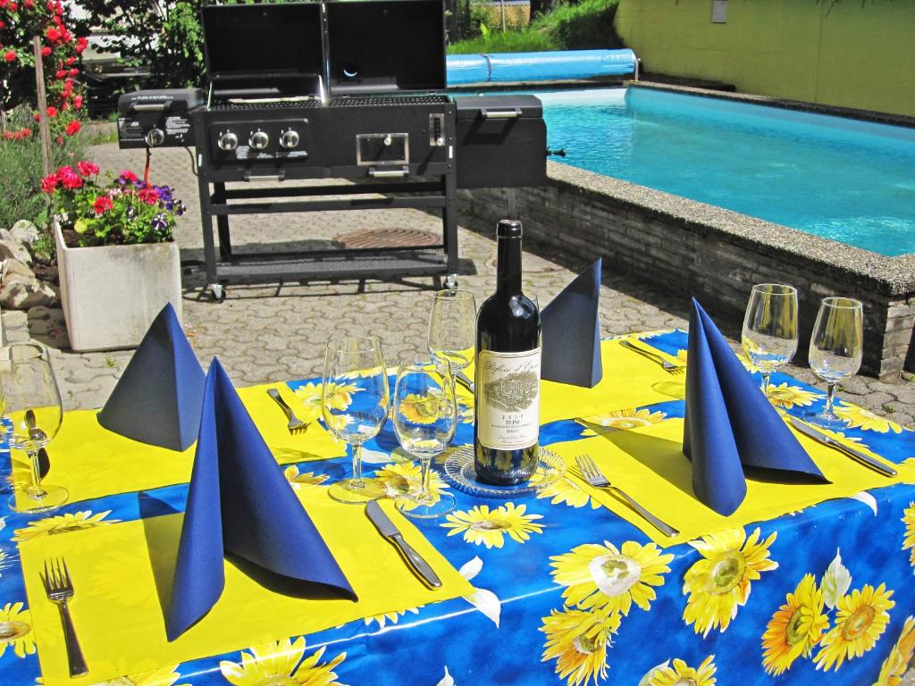 a table with a bottle of wine and glasses on it at Hotel Krone in Attinghausen