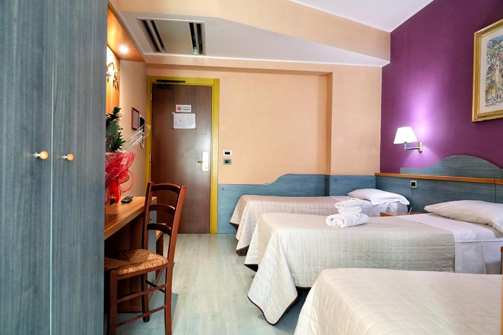 Postel nebo postele na pokoji v ubytování Hotel Al Castello