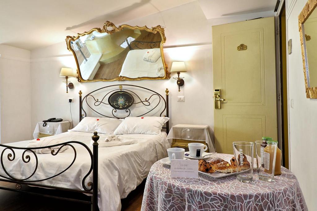Postel nebo postele na pokoji v ubytování Hotel Al Castello
