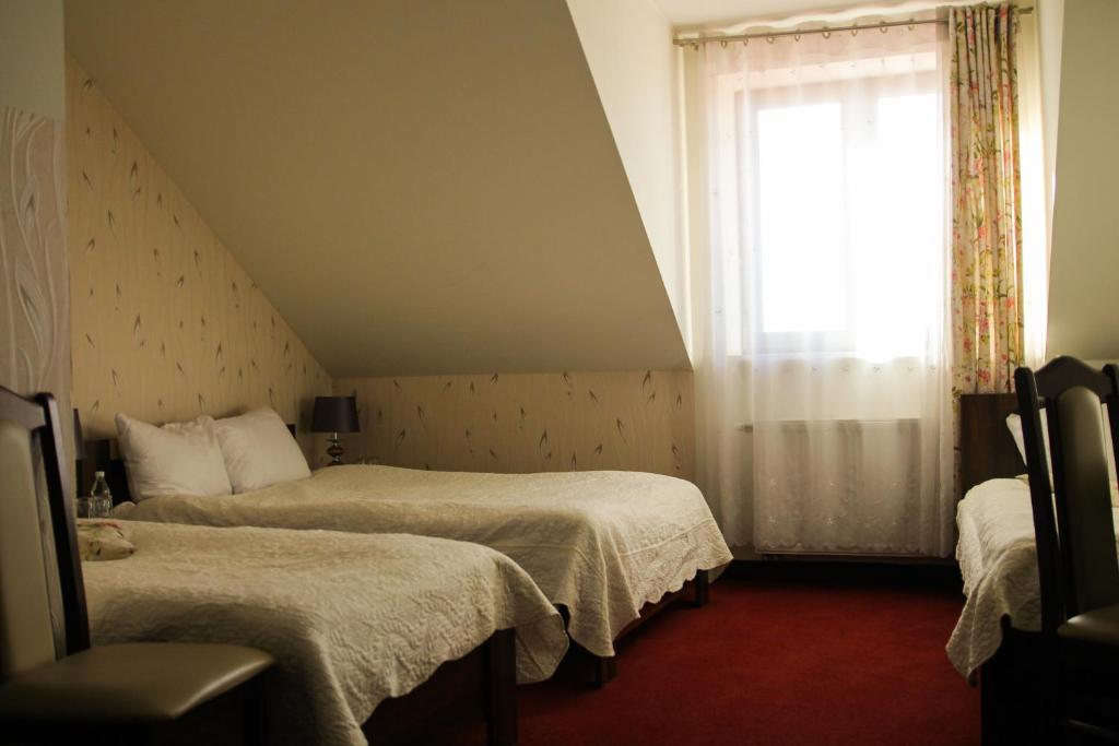 Postel nebo postele na pokoji v ubytování Prymus
