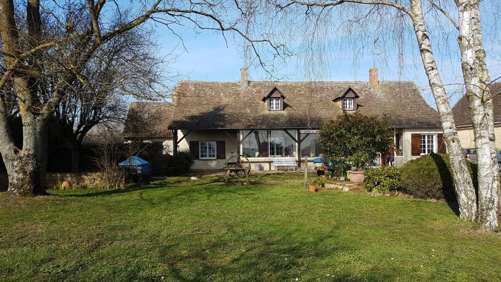 a large house with a grass yard in front of it at Le Vitard in Volnay