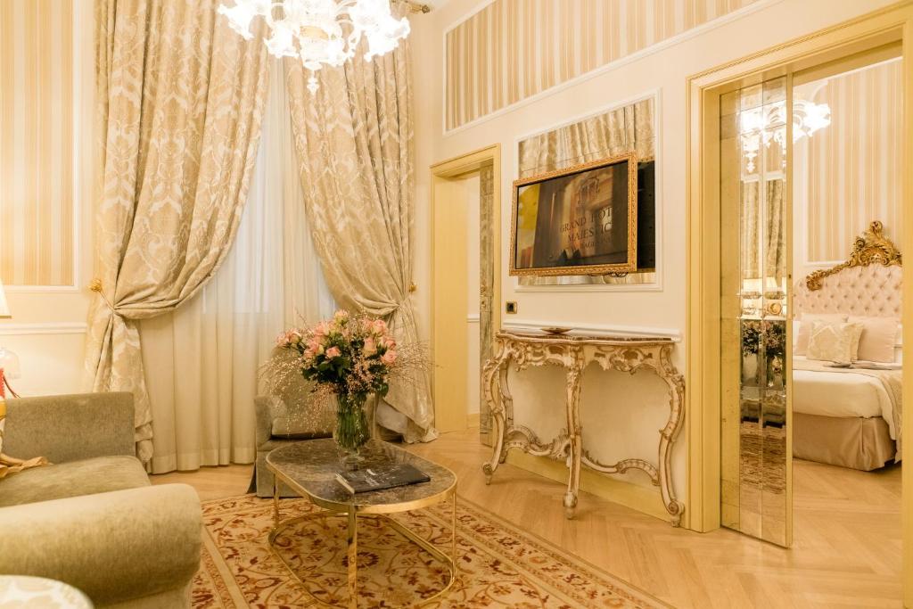 a living room with a vase of flowers on a table at Grand Hotel Majestic gia' Baglioni in Bologna