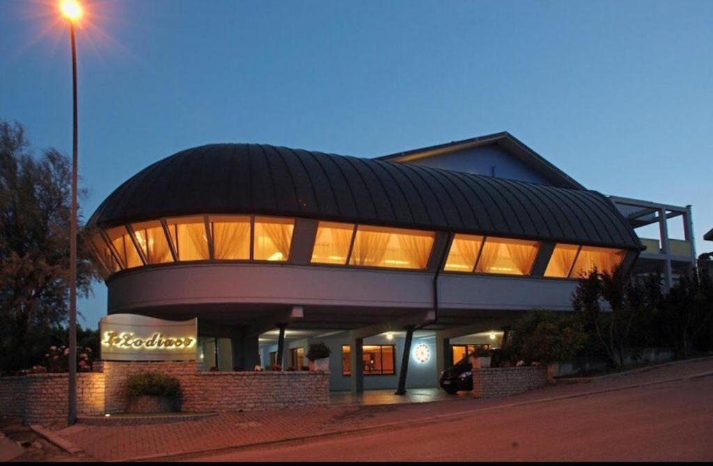 a building with a sign in front of it at Hotel Lo Zodiaco in Oppido Lucano