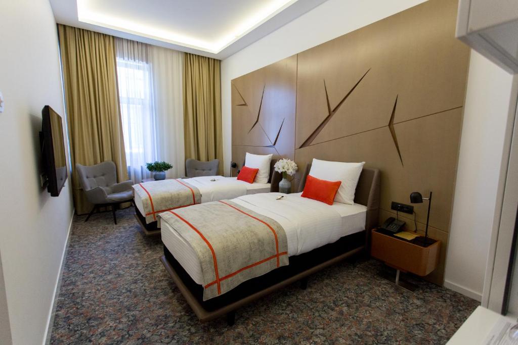 Postel nebo postele na pokoji v ubytování Hotel Austria & Bosna