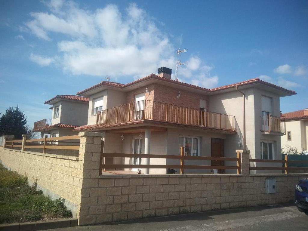 a large house with a fence in front of it at La casita de Villalarreina in Casalarreina