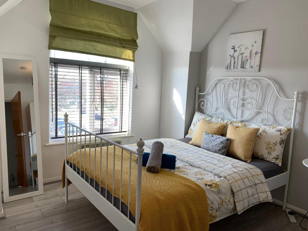 a bedroom with a bed and a window at Eskdaill Place Apartment in Kettering
