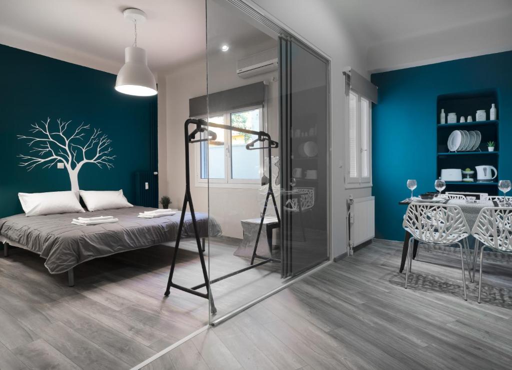 a bedroom with a bed and a blue wall at Autonomous house in the heart of Plaka in Athens