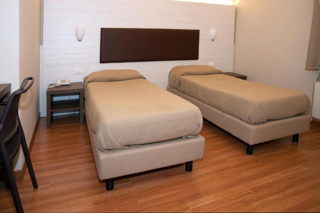 Postel nebo postele na pokoji v ubytování HOTEL BUCA DI BACCO