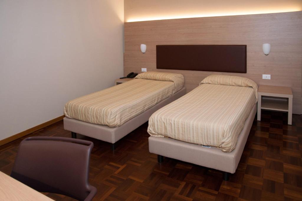 Postel nebo postele na pokoji v ubytování HOTEL BUCA DI BACCO