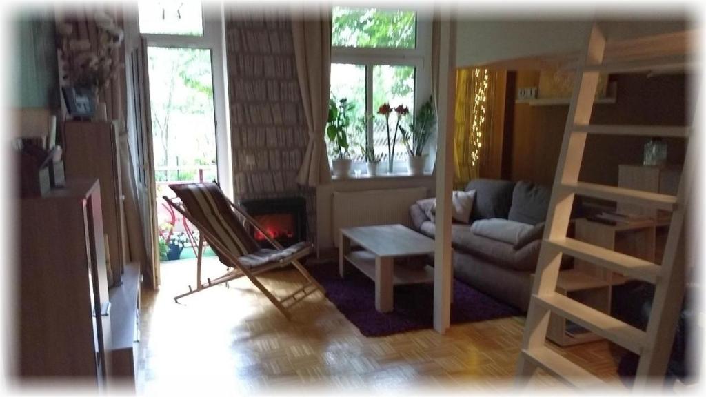 a living room with a couch and a chair at Mitten in Leipzig Wohnung 1 in Leipzig