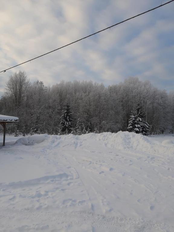 a snow covered slope with a ski lift at Huntingbox in Purila