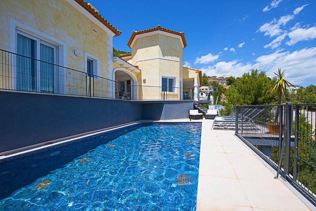 a swimming pool in front of a villa at Villa Mar in Calpe