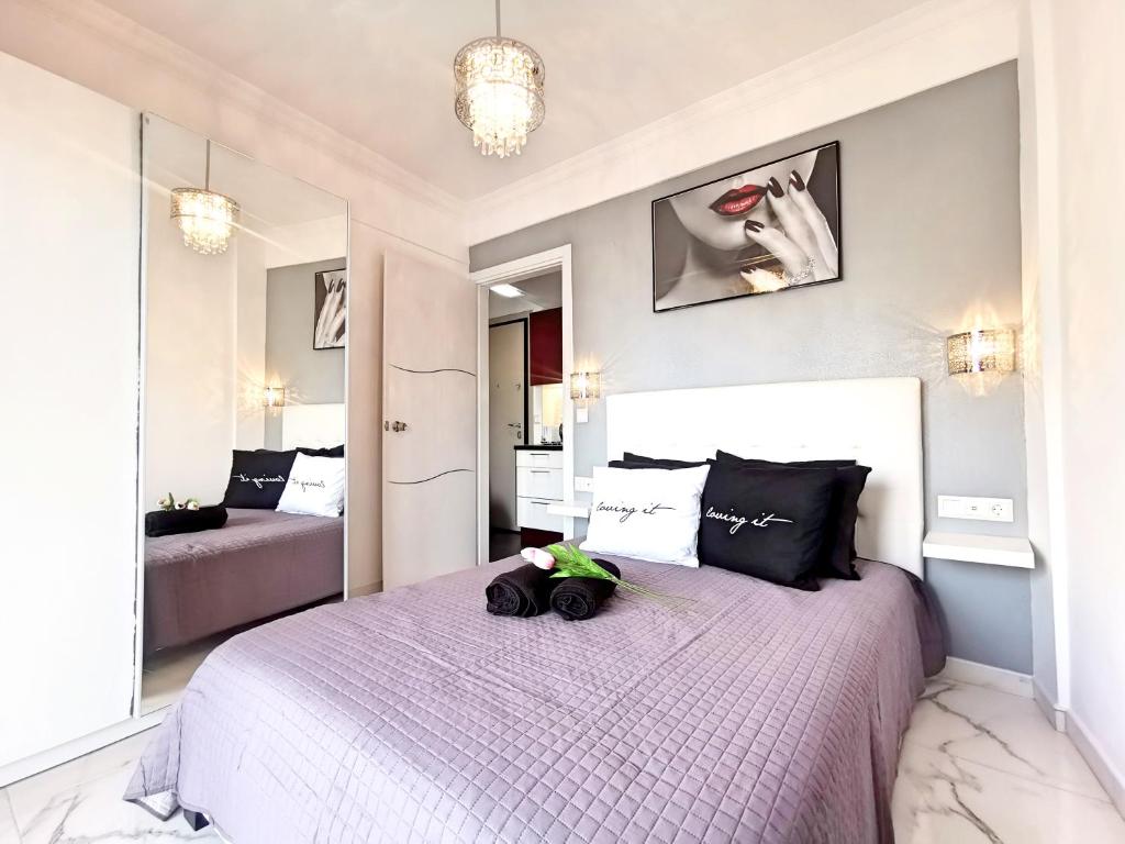 a bedroom with a large bed with a stuffed animal on it at Pure BLISS Luxury Beachfront Apartment with Panoramic Sea Views, Electric BBQ, Gym Equipment and More in Agia Triada